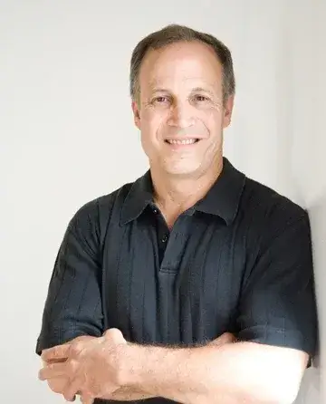 Portrait of Gary Mettler against a grey background
